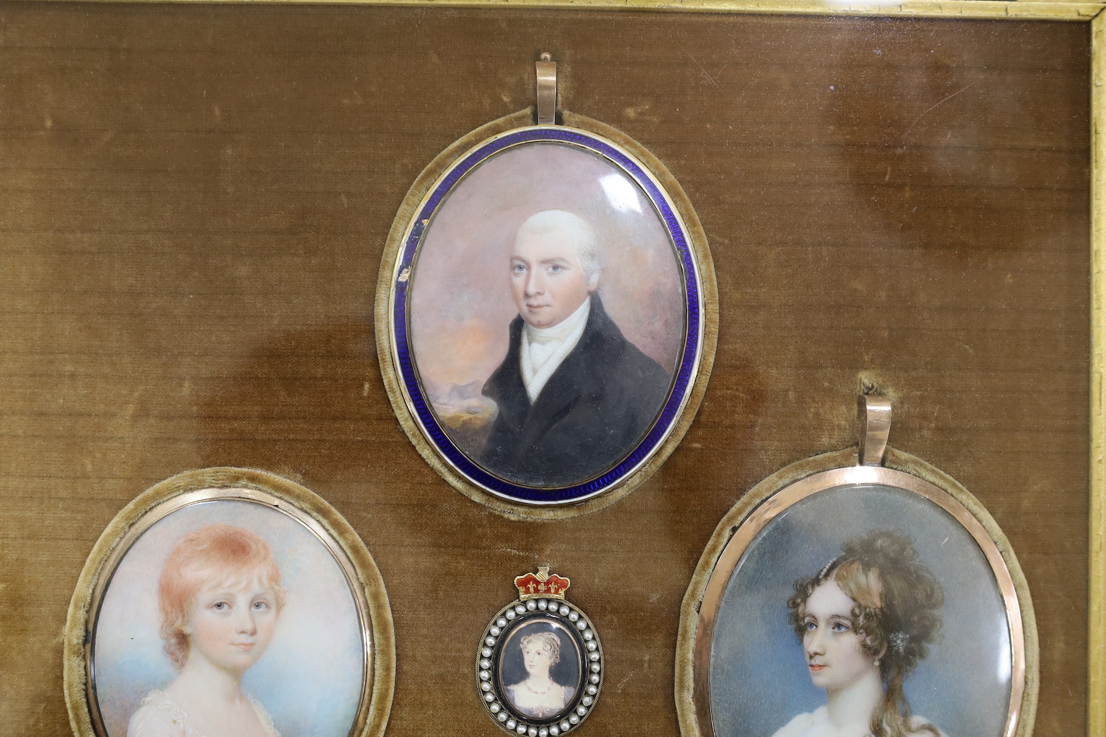 A group of five 19th century portrait miniatures on ivory, framed as one, in a decorative gilt and velvet mount rosewood frame. Overall 36 x 32cm